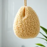 Learn how to clean a loofah naturally with an image showing a pristine loofah in a sunlit bathroom.