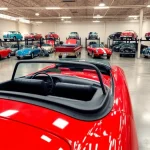 Showcasing classic car storage with a gleaming red vintage car under bright lights.
