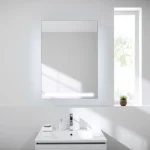 Showcasing a stylish bathroom cabinet with mirror and light integrated into an elegant modern setting.