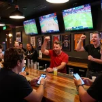 Exciting sports betting scene at a bar, where patrons are actively placing bets on rr88bet.
